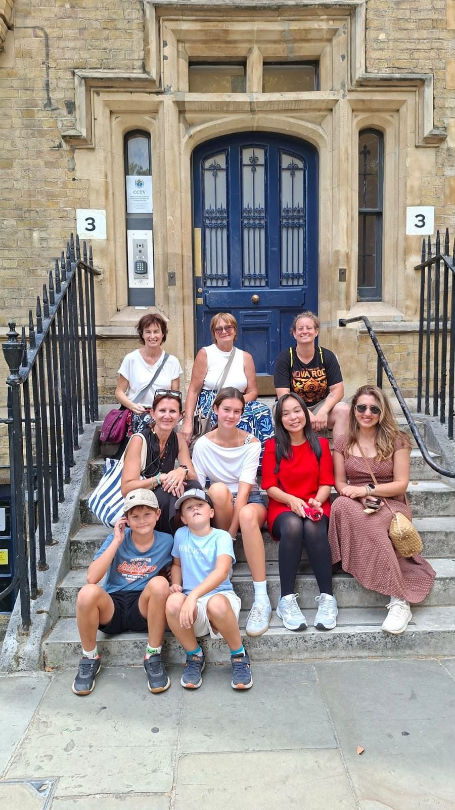 A BeExplorers group of adults and children on the steps of a London townhouse