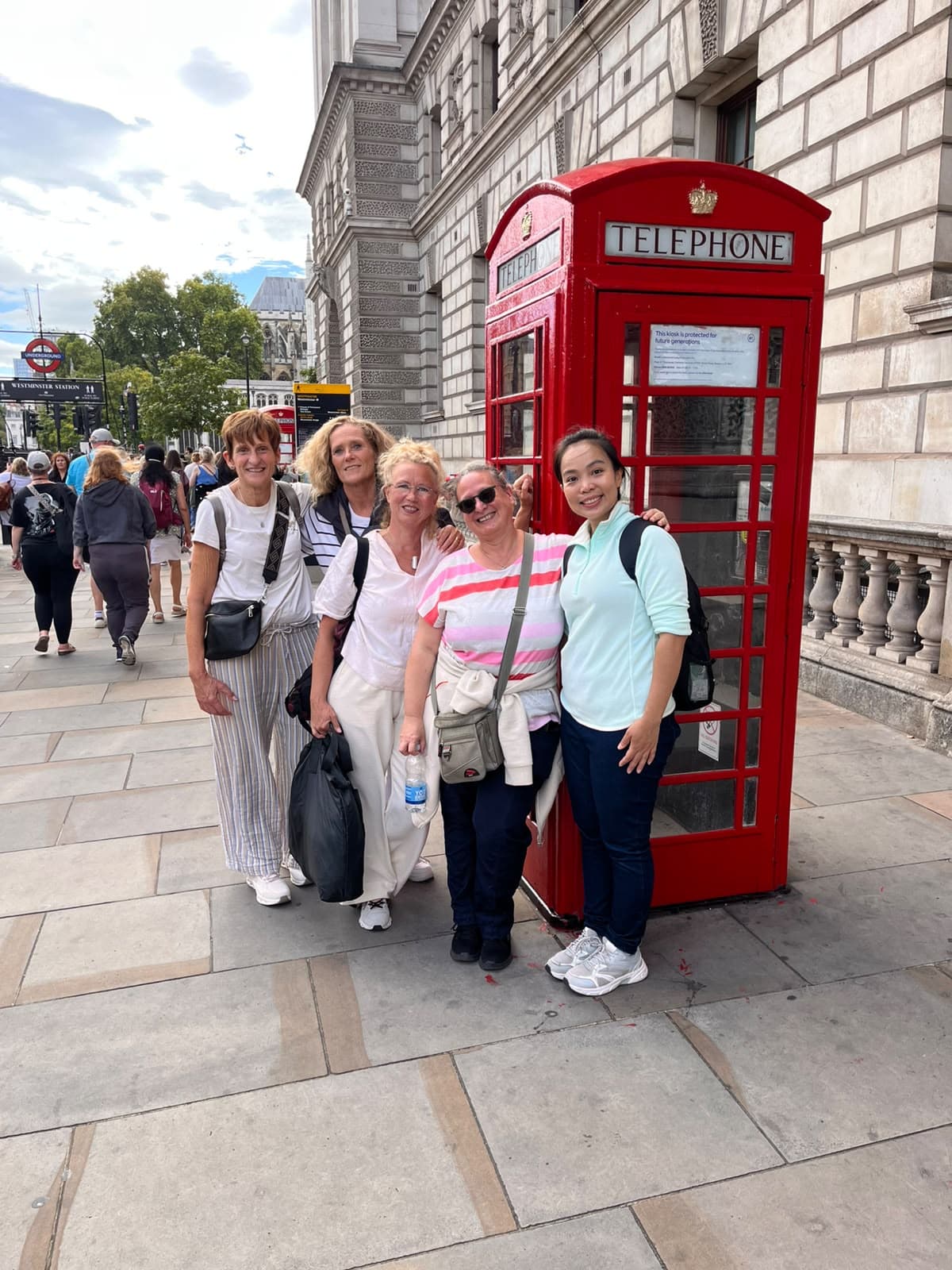 A BeExplorers group beside a red telephone box near Westminster station