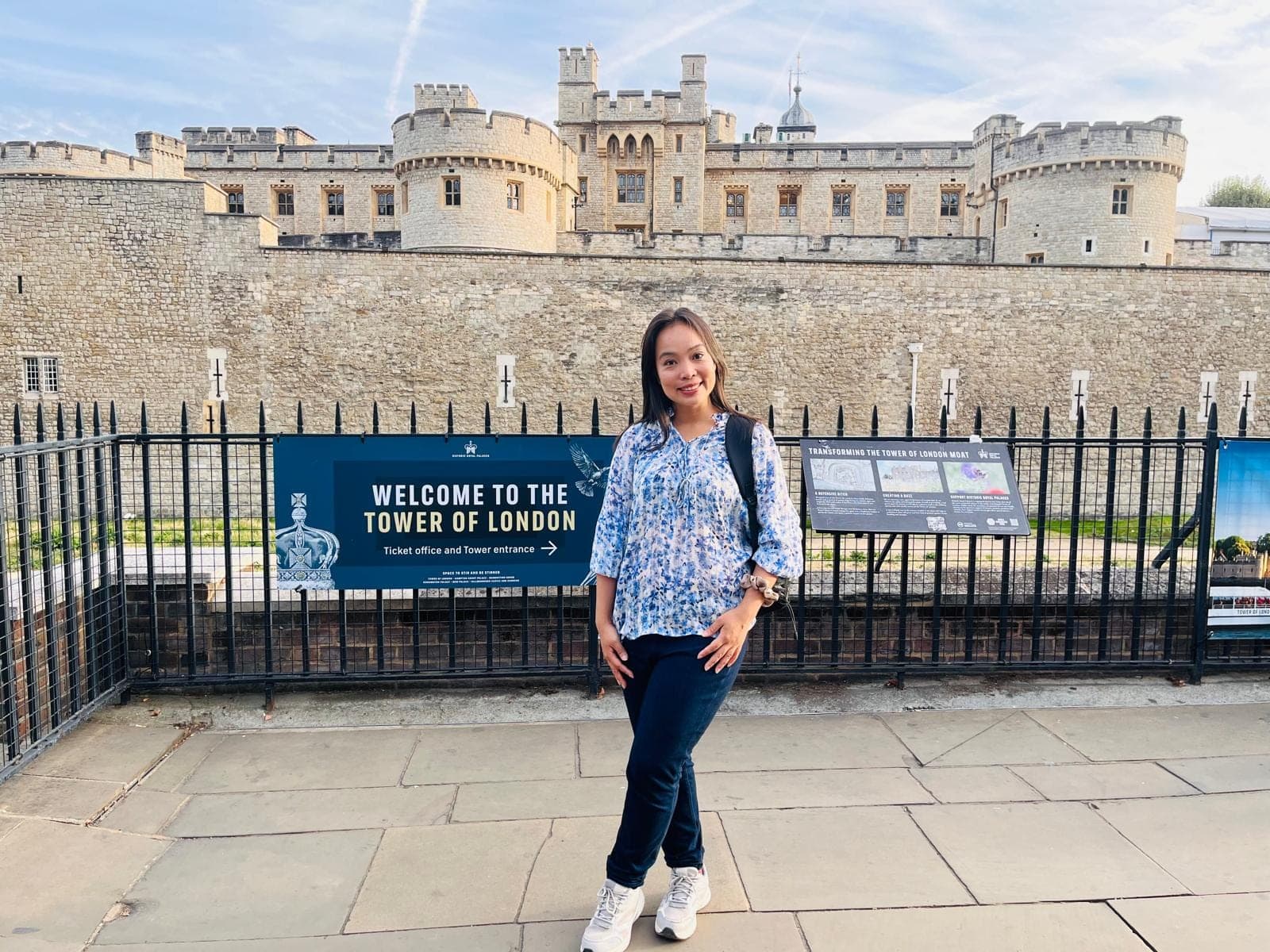 The BeExplorers guide at the entrance to the Tower of London, with the fortress walls behind