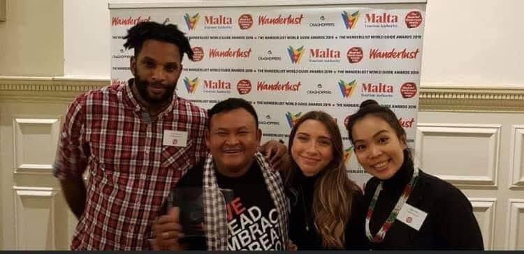 The BeExplorers guide with fellow guides in front of the Wanderlust World Guide Awards 2019 backdrop