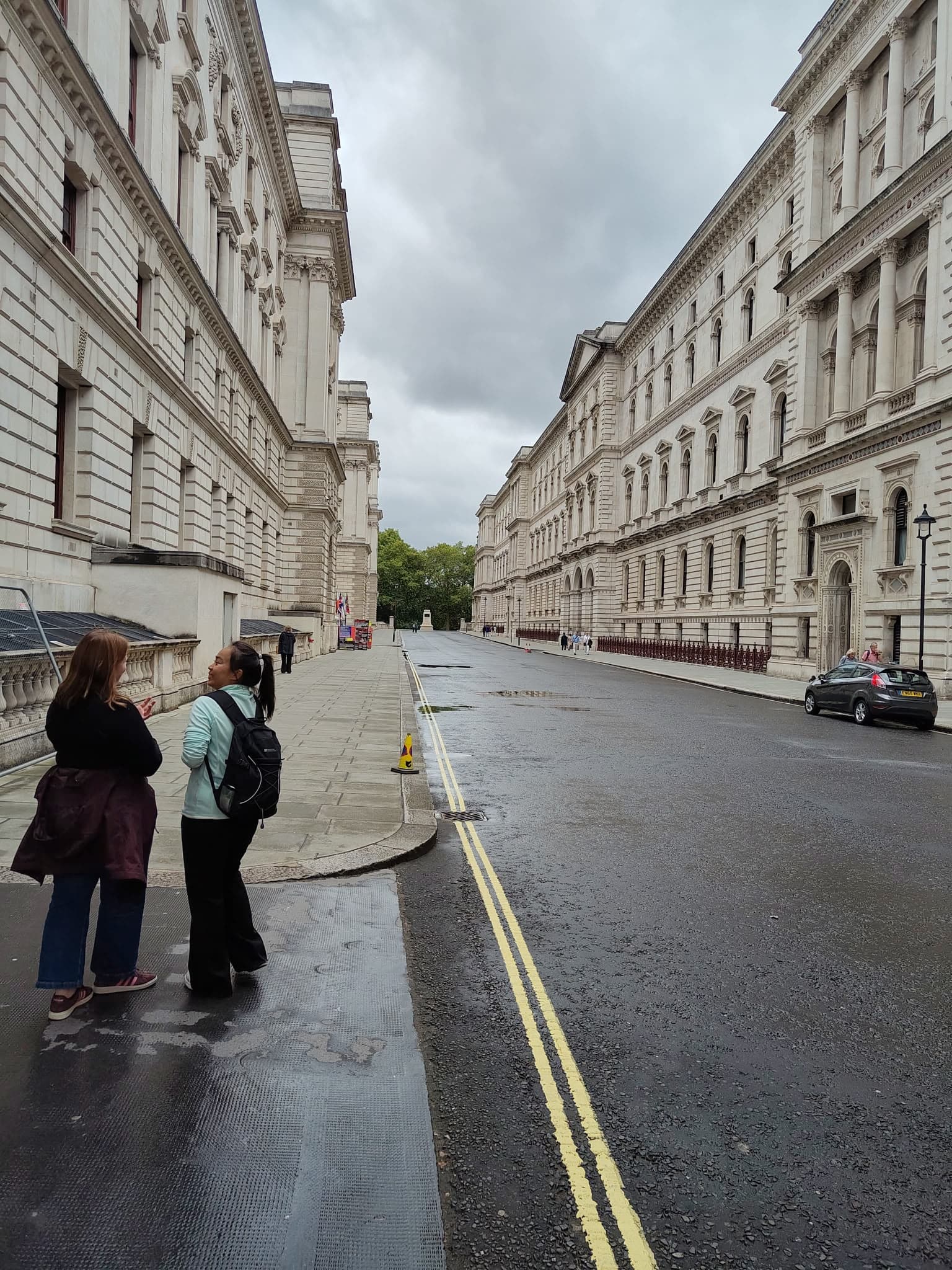 The BeExplorers guide explaining the government buildings on King Charles Street to a guest